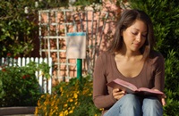 Girl sitting and reading a book.