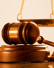 A gavel lying on its stand.