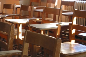 Rows of empty chairs with desks attached